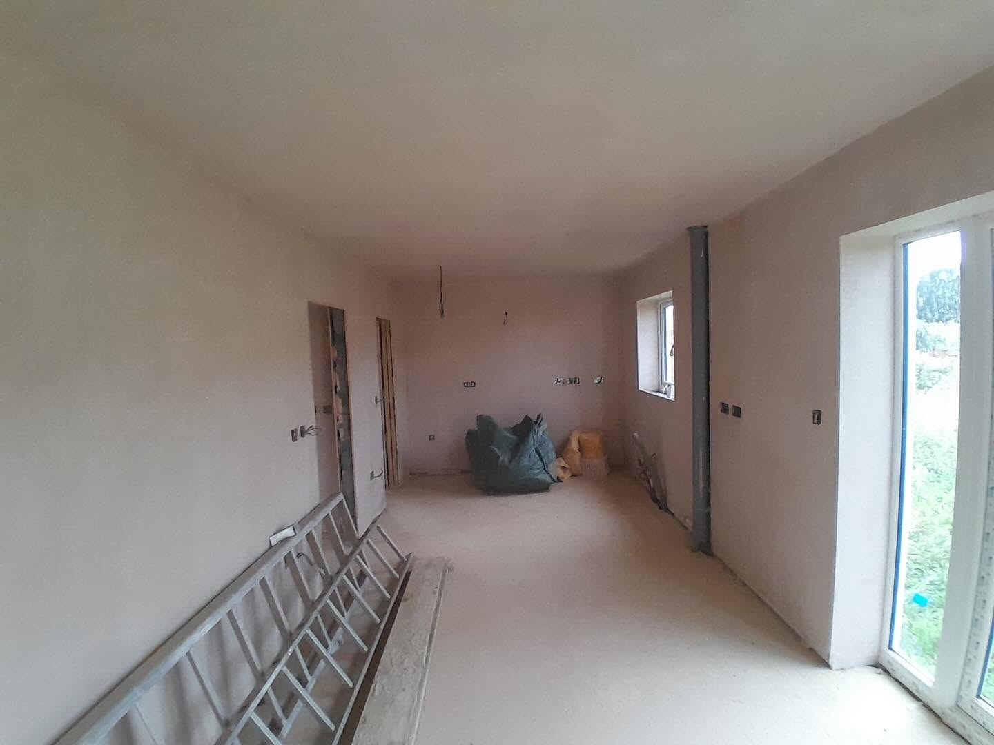 Long extension room freshly plastered, walls drying
