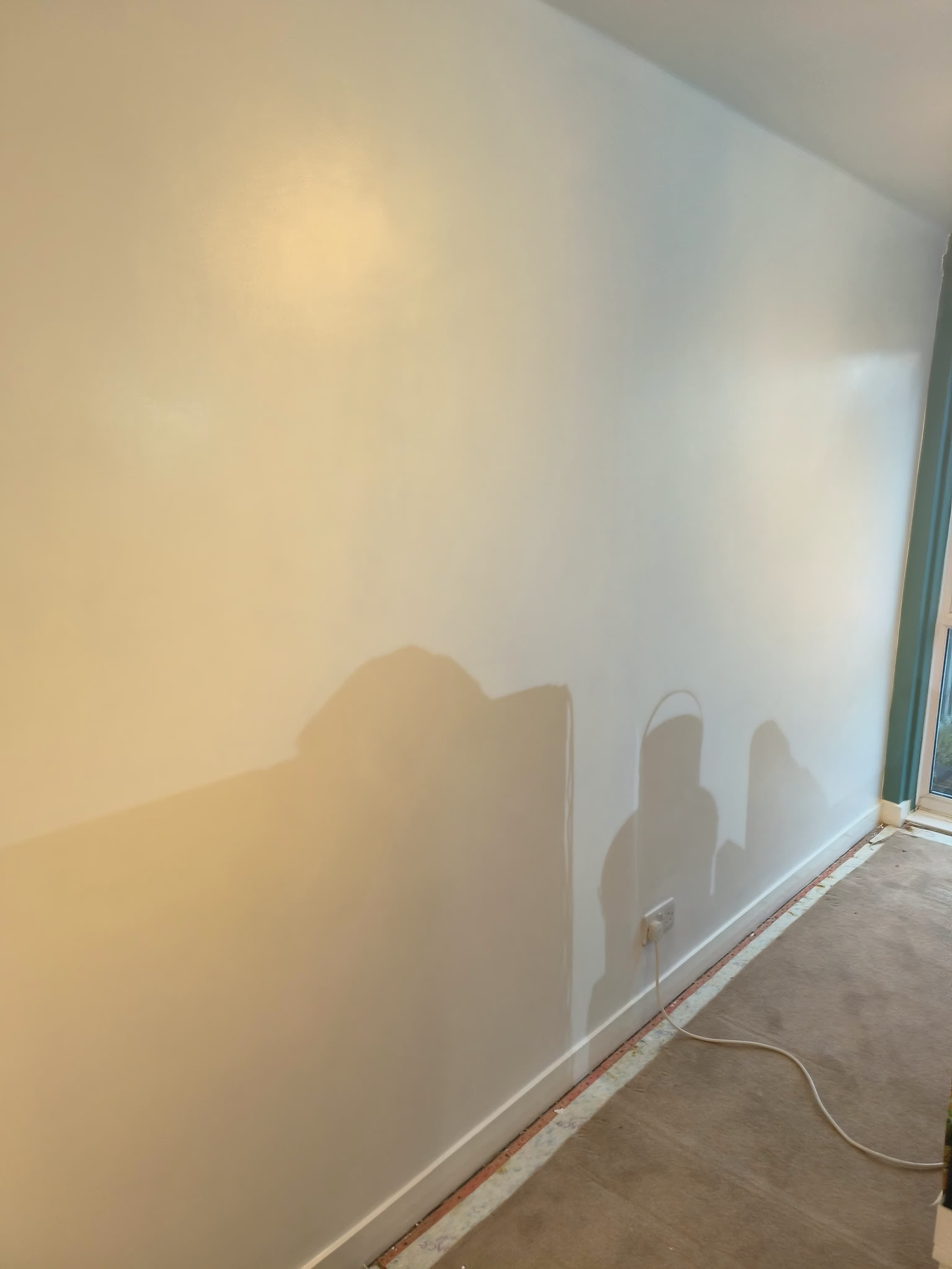 A long wall plastered smooth and painted