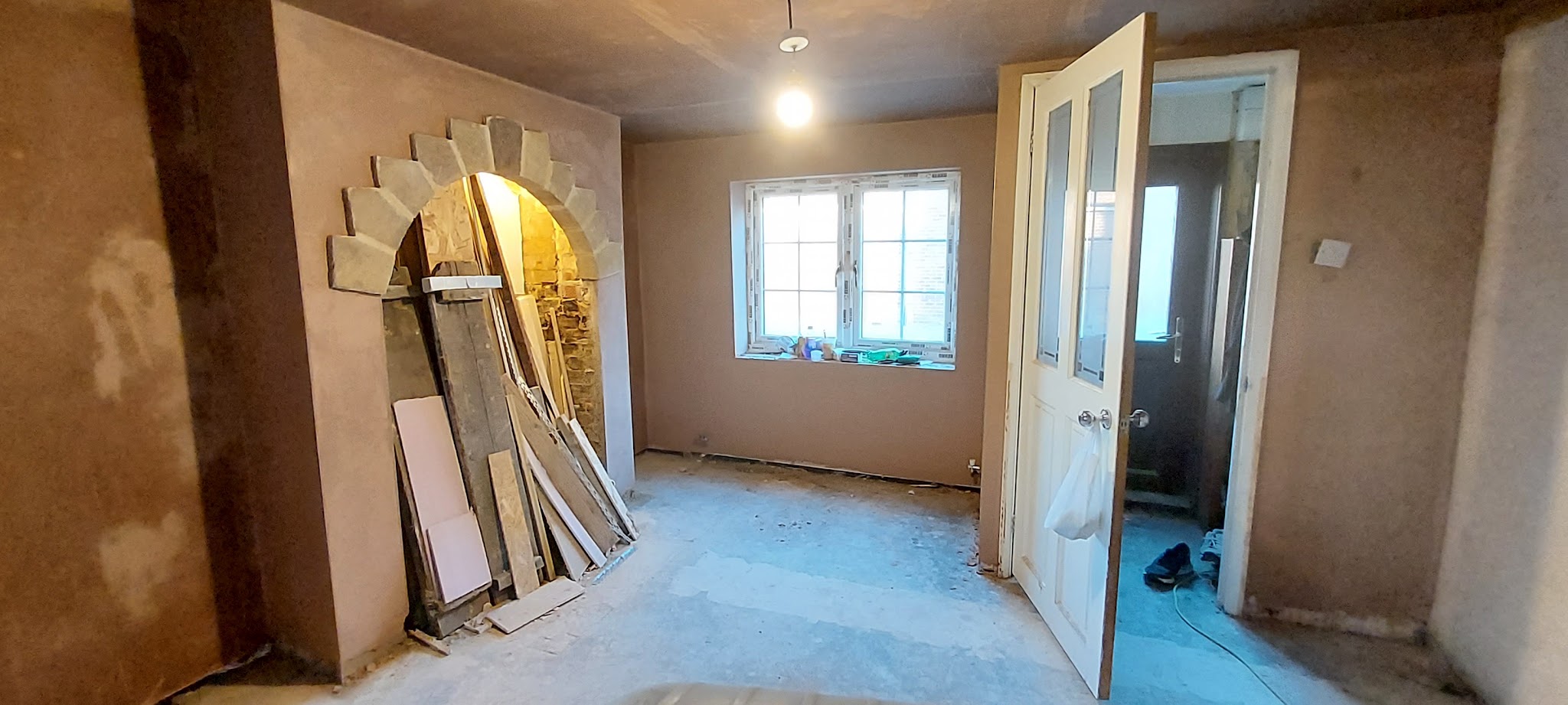 Whole room plastered around a stone arch